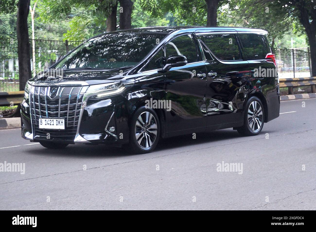 Luxury MPV, black  Toyota Alphard in a road, at business and commercial distric TB Simatupang Stock Photo