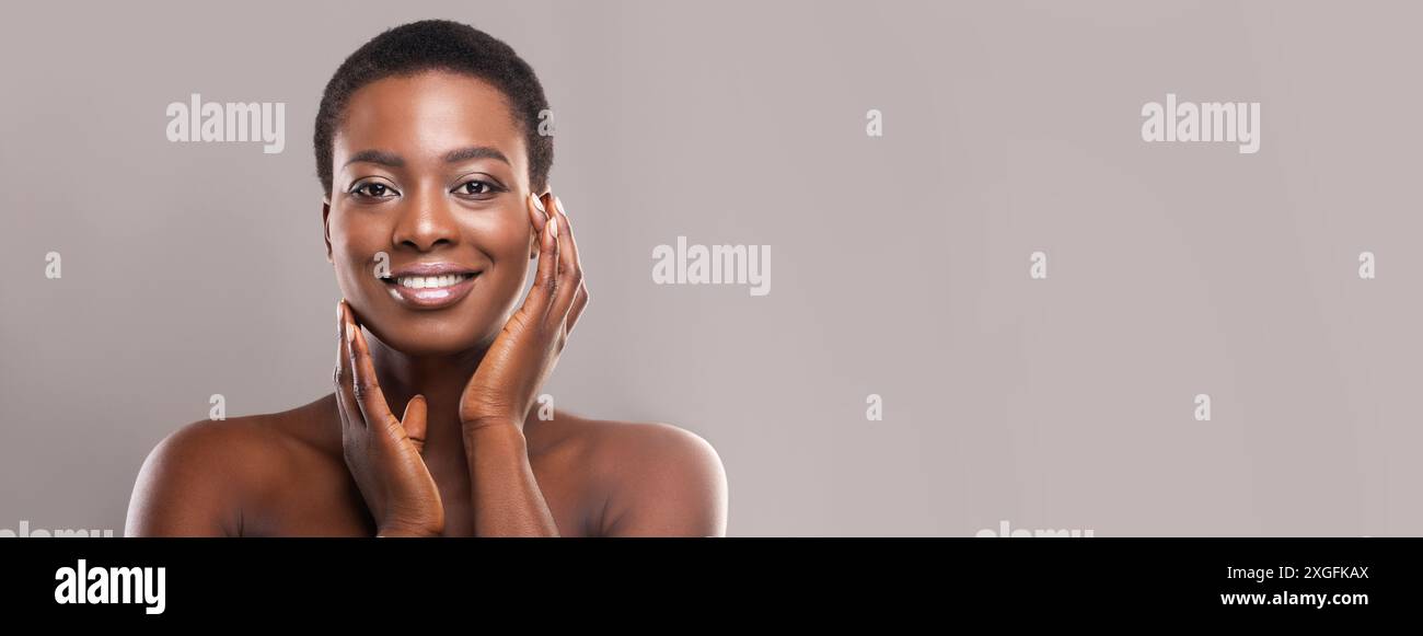 Beautiful black woman with short hair touching her smooth cheeks Stock ...