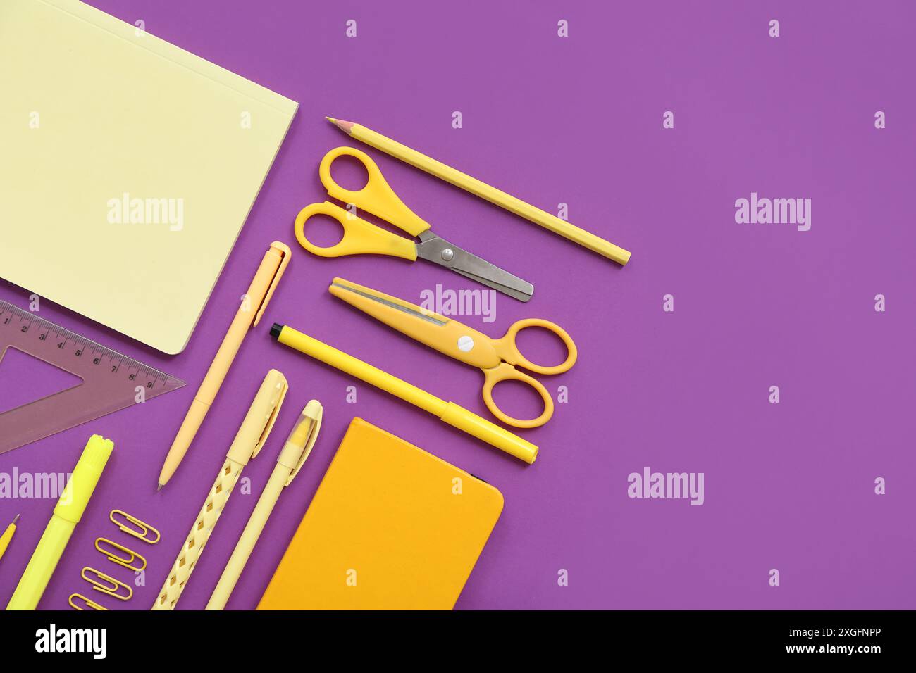 Different stationery on purple background Stock Photo