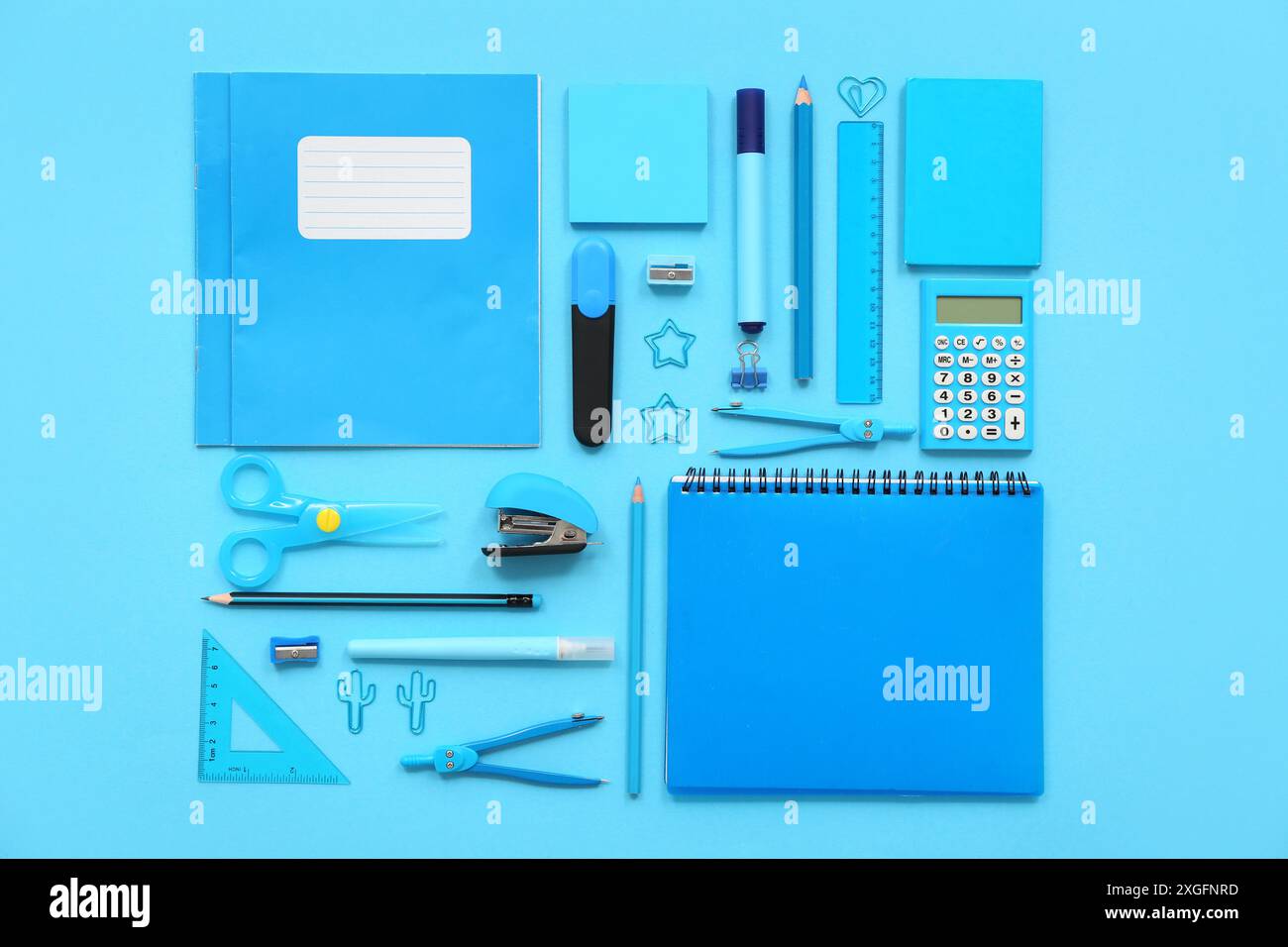 Composition with notebooks and different stationery on blue background Stock Photo