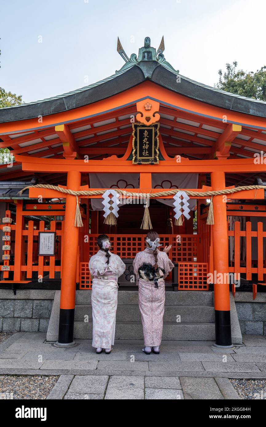Women in traditional dress visiting temples and shrines during the cherry blossom (sakura) season and festivals, Kyoto, Honshu, Japan, Asia Stock Photo