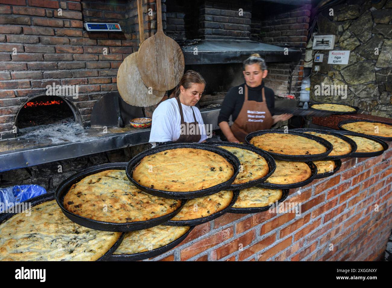 Cooking organic corn patties with nettles in one of the traditional ovens at  Mrizi's agrotourism organic farm and restaurant at Fishte in Lezhe count Stock Photo