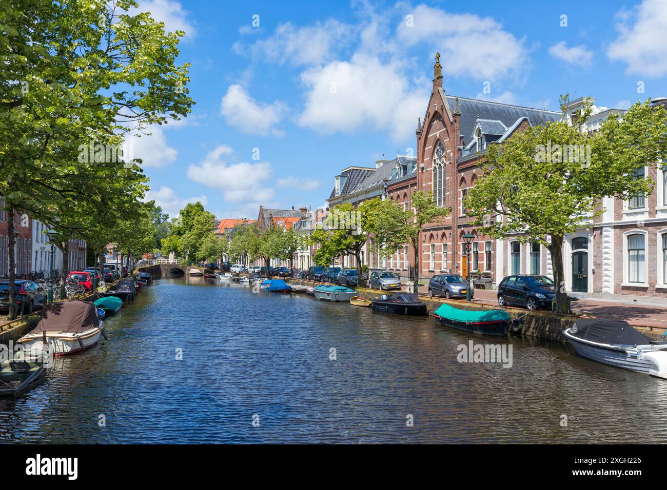 Oudegracht canal seamed with small boats at the old town of Alkmaar, The Netherlands Stock Photo