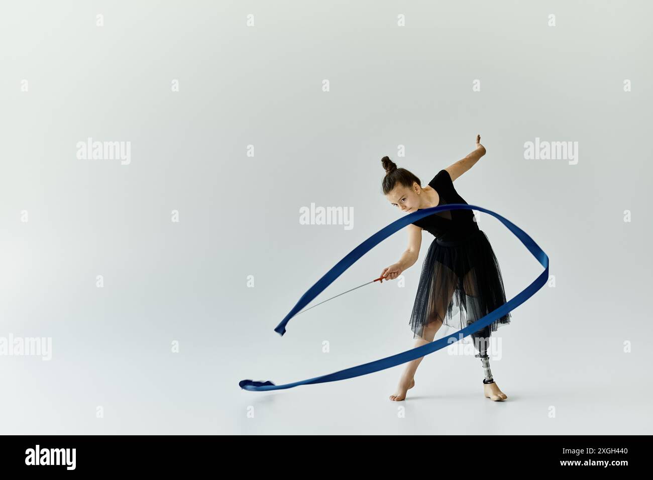A young girl with a prosthetic leg performs a graceful gymnastics ...