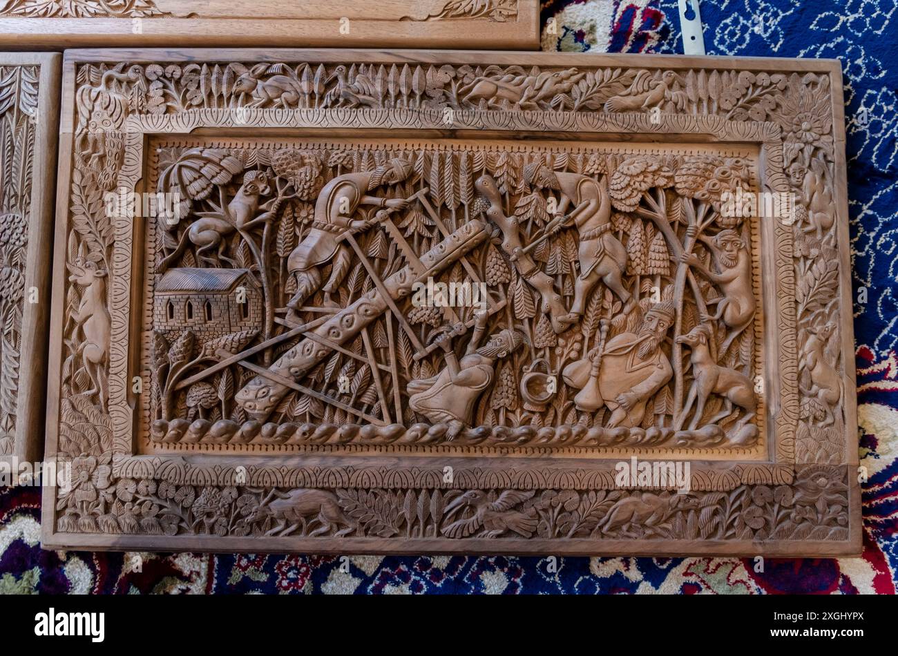 a-carved-piece-of-wood-depicting-men-cutting-trees-in-forest-is