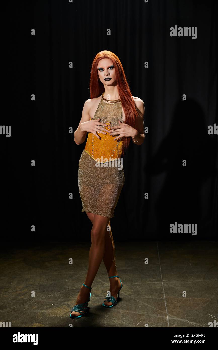 A drag diva poses in a sparkling gold mesh dress Stock Photo - Alamy
