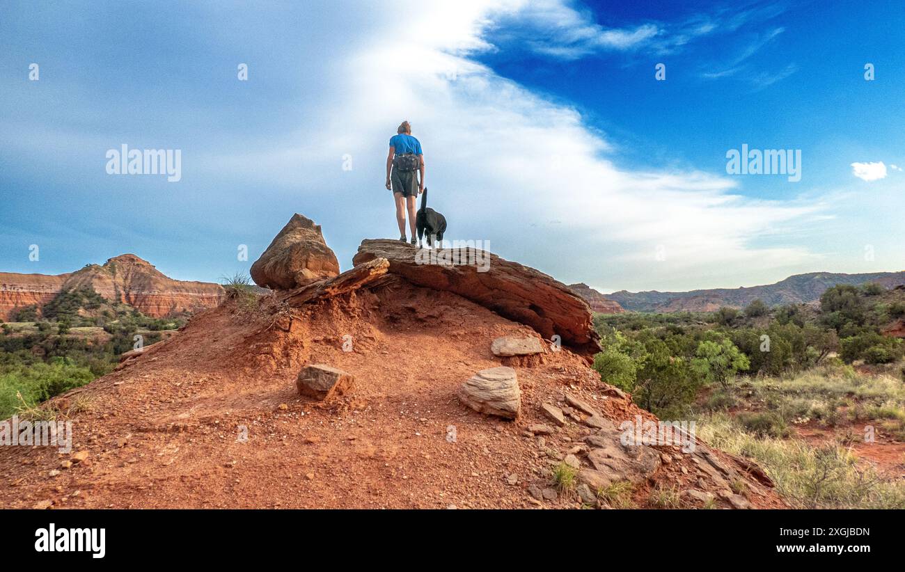 A single woman and her black lab hiking in Palo Duro Canyon State Park, Texas. Stock Photo