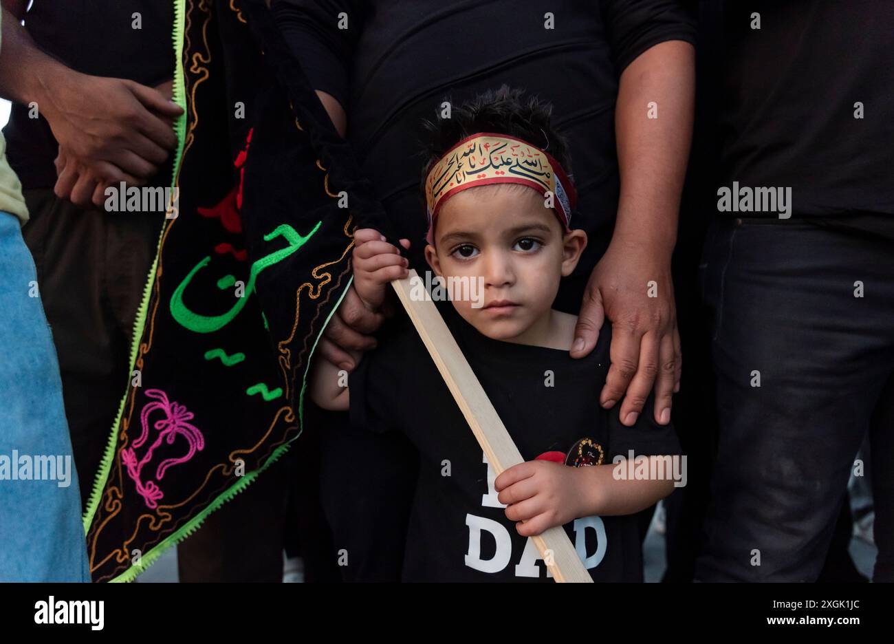 A Kashmiri Shia Muslim child looks for a picture as he holds an ...