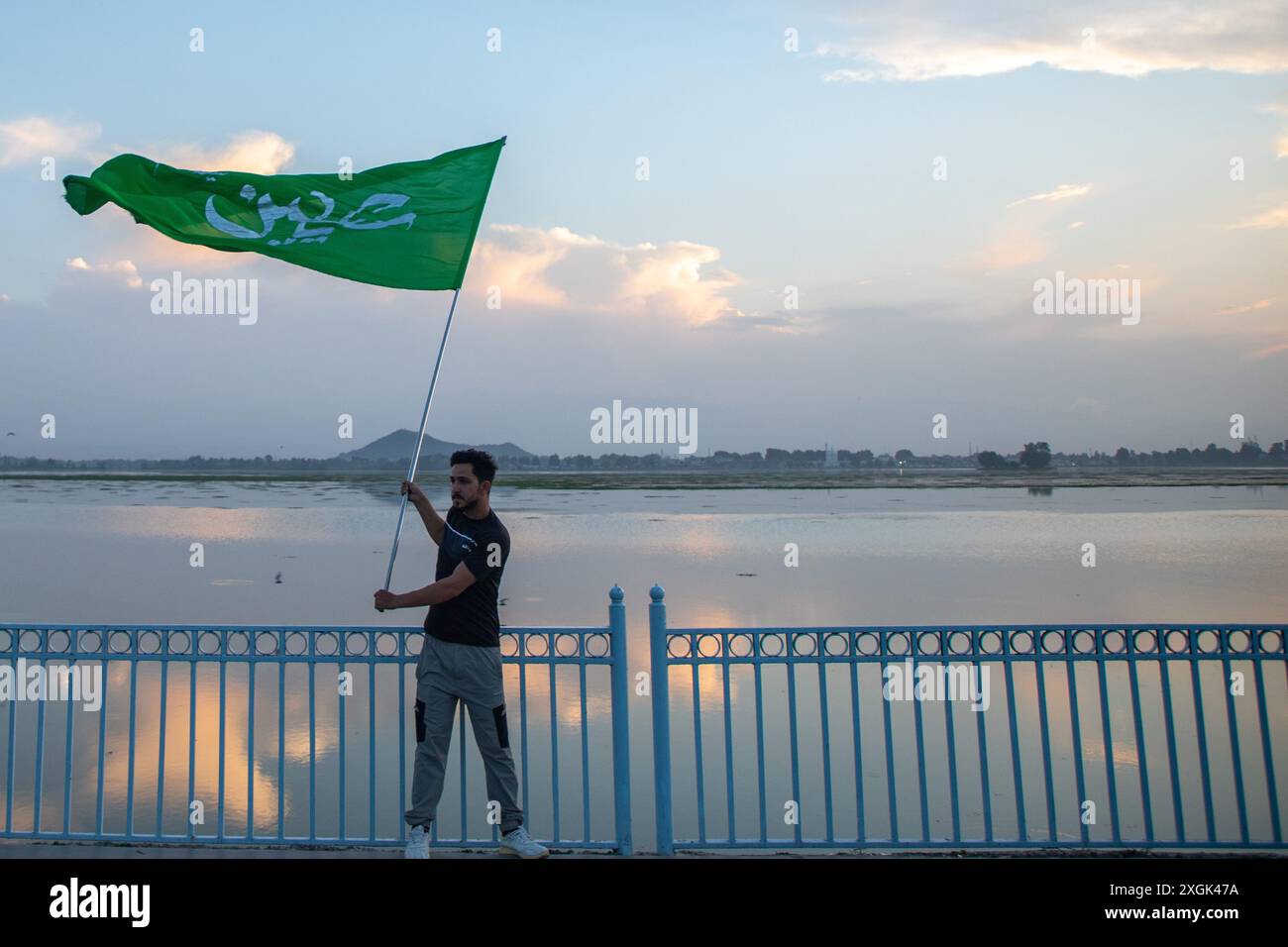 Srinagar, India. 09th July, 2024. A Kashmiri Shiite Muslim man waves an ...