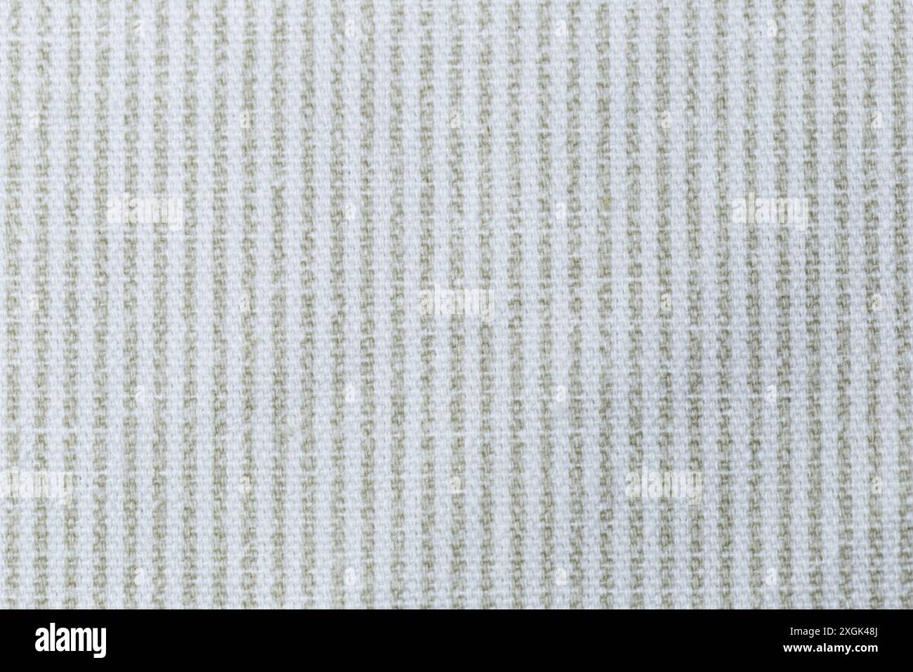 A white and green vertical striped fabric with a pattern of squares. The fabric is very plain and simple. Texture. Stock Photo