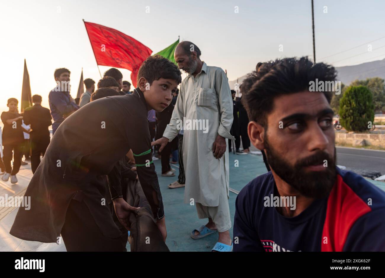Kashmiri Shia Muslims install a tall religious flag on a road during ...