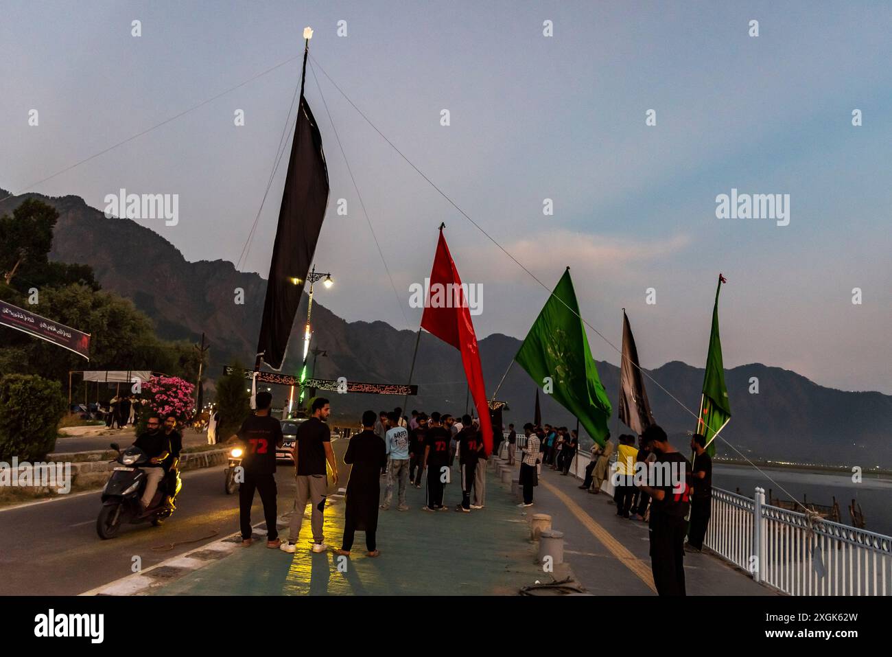 Kashmiri Shia Muslims hold flags as they erect a tall religious flag on ...
