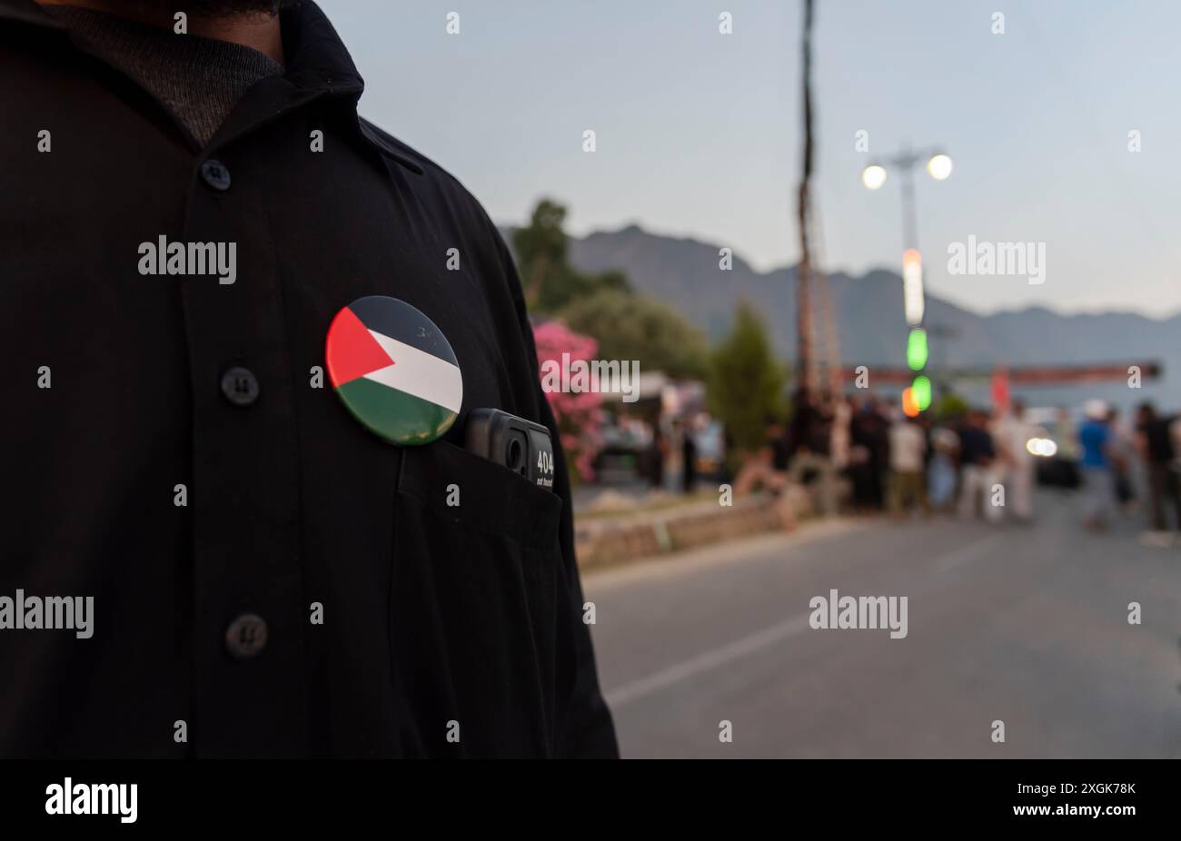 A Kashmiri Shia Muslim wearing a Palestinian flag brooch on his t-shirt ...