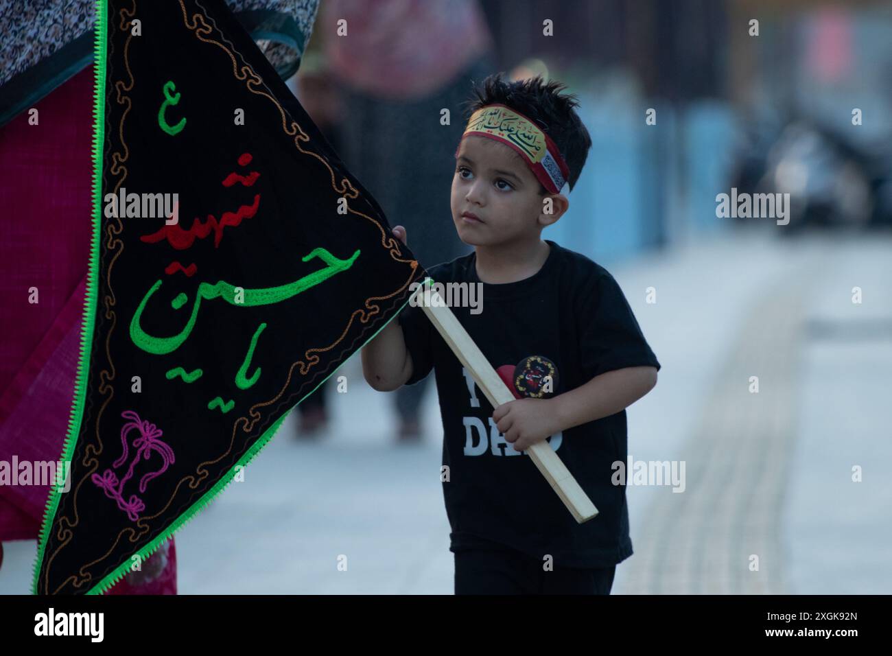 Srinagar, India. 09th July, 2024. A Kashmiri Shiite Muslim kid holds an ...