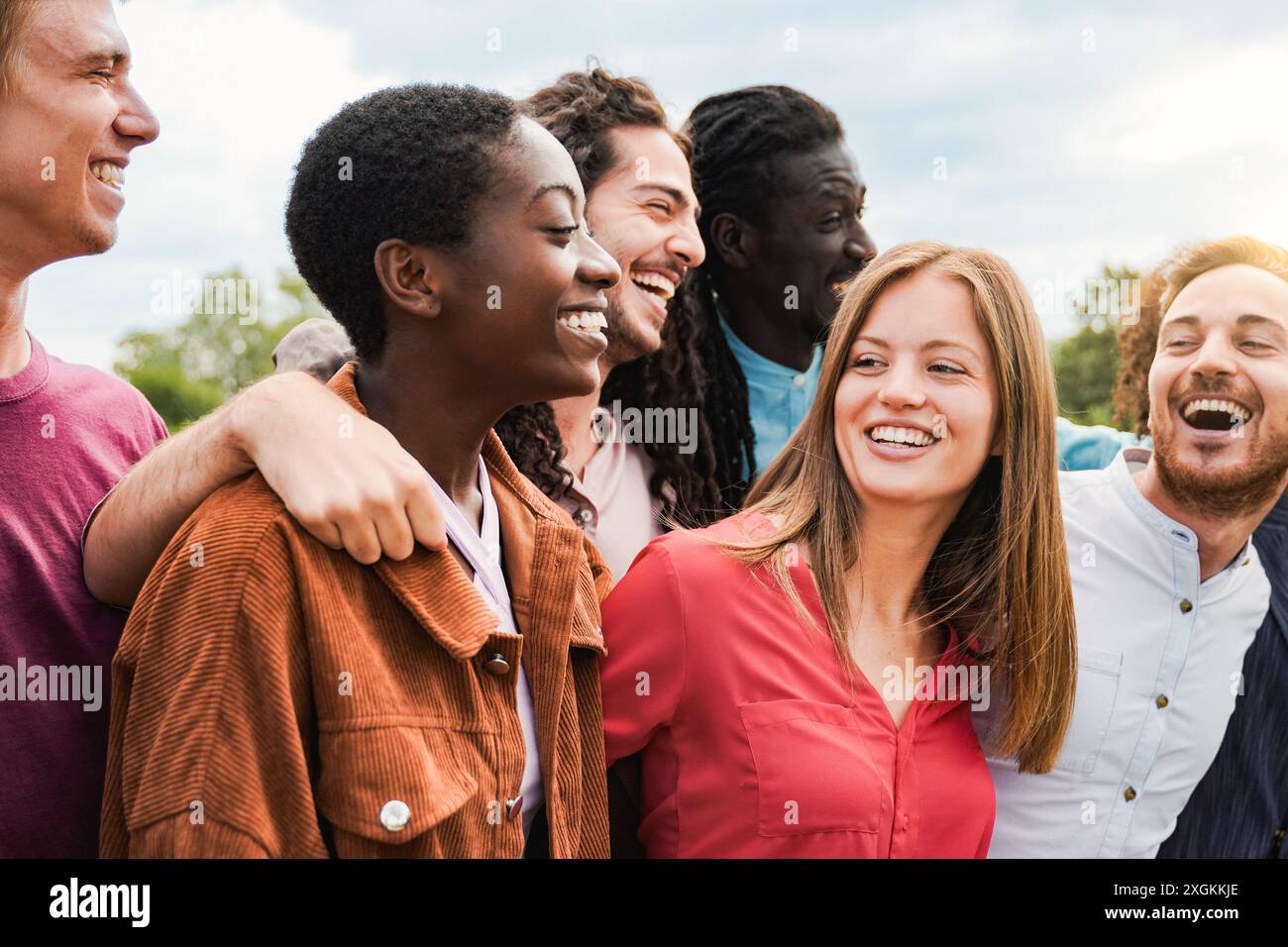 Group of friends having fun celebrating outdoors. Young diverse people enjoy summer vacations together Stock Photo