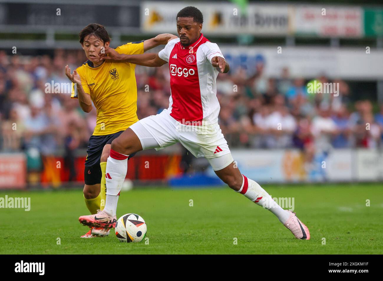 Oldebroek, Netherlands. 09th July, 2024. OLDEBROEK, NETHERLANDS - JULY 9: Rihito Yamamoto of STVV, Chuba Akpom of AFC Ajax during the Pre-season friendly match between AFC Ajax and STVV at Sportpark Bovenmolen on July 9, 2024 in Oldebroek, Netherlands. (Photo by Ben Gal/Orange Pictures) Credit: Orange Pics BV/Alamy Live News Stock Photo