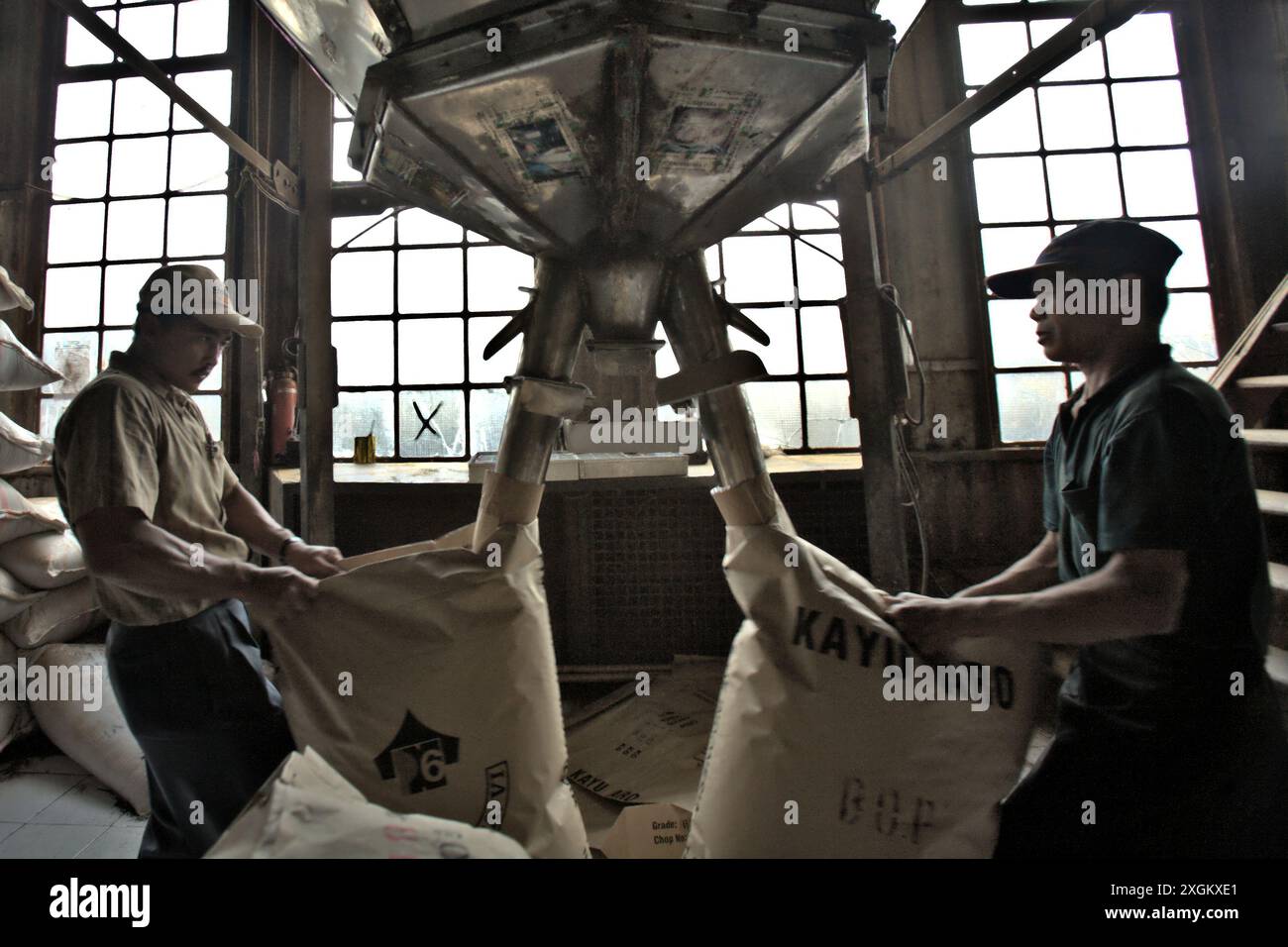 Workers Pack Tea Powder Into Paper Sacks At Kayu Aro Tea Factory In workers-pack-tea-powder-into-paper-sacks-at-kayu-aro-tea-factory-in