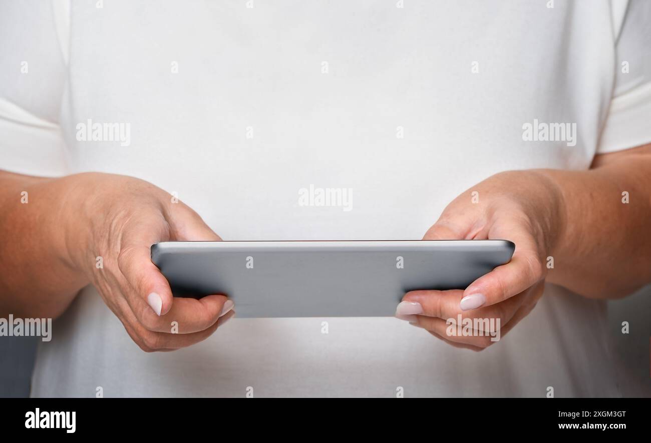 Senior woman using tablet close-up Stock Photo