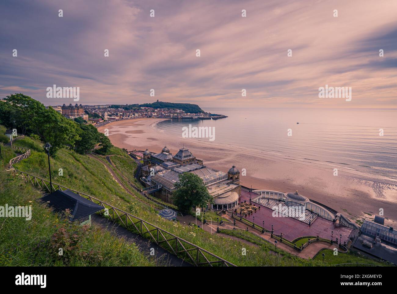 Scarborough South Bay shortly after sunrise. The clifftop vantage point offers views of the clifftop gardens, Spa, beach, Castle Headland and harbour Stock Photo