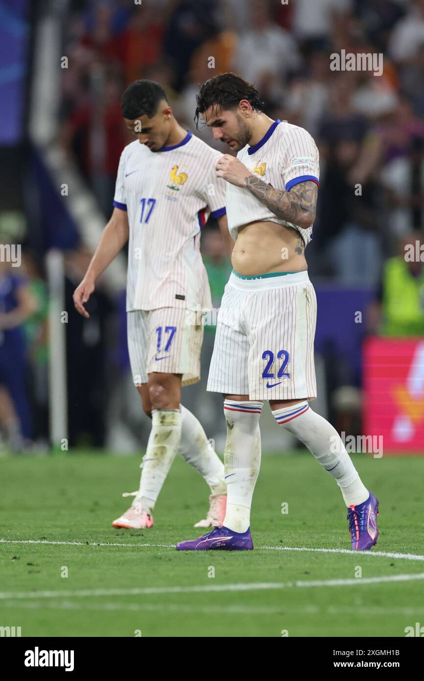 Munich , Germany 09.07.2024: French players Theo Hernandez of France, William Saliba of France   disappointed after defeat in the UEFA EURO 2024 semi- Stock Photo