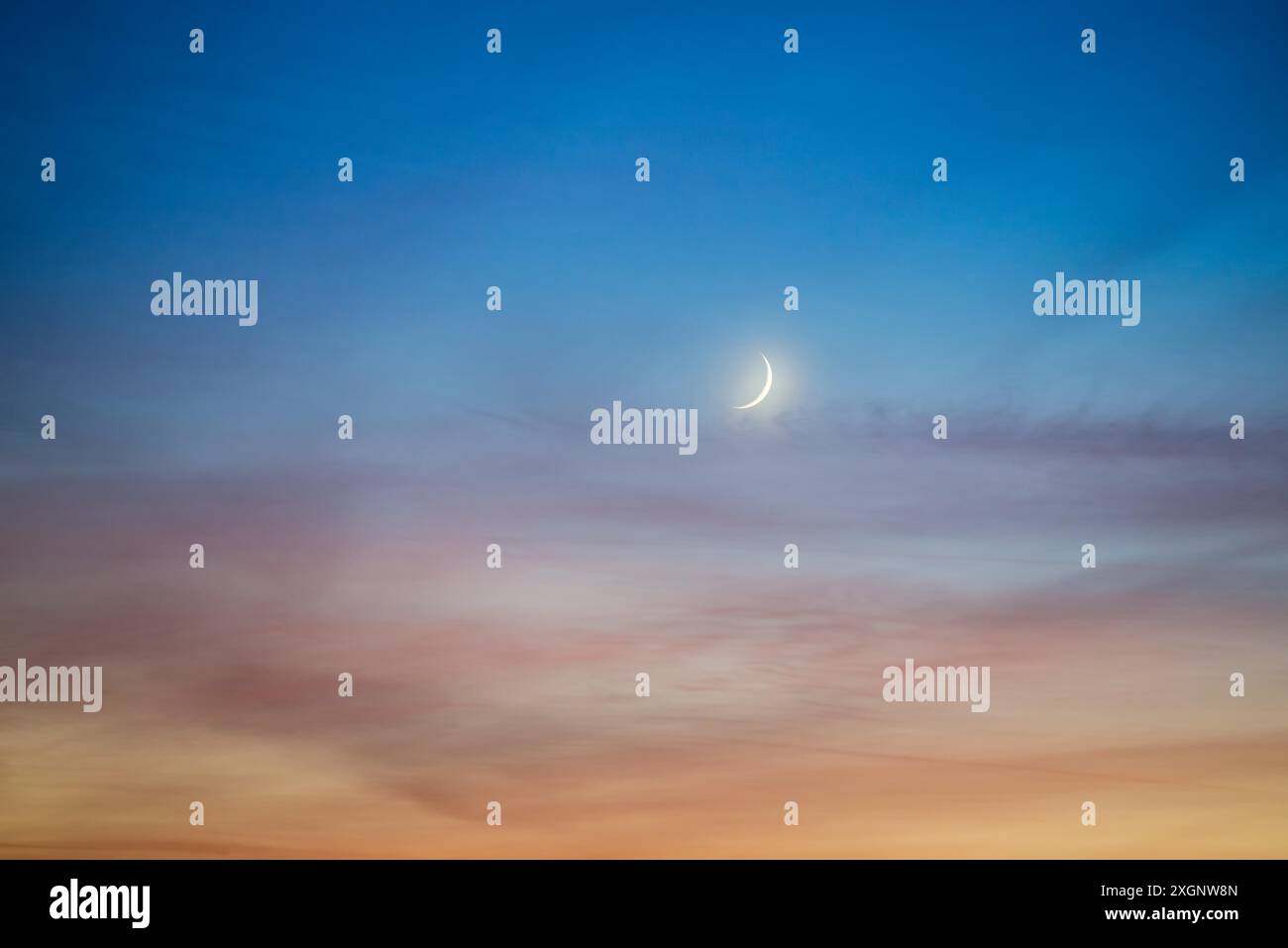 Crescent moon on dark sky Stock Photo
