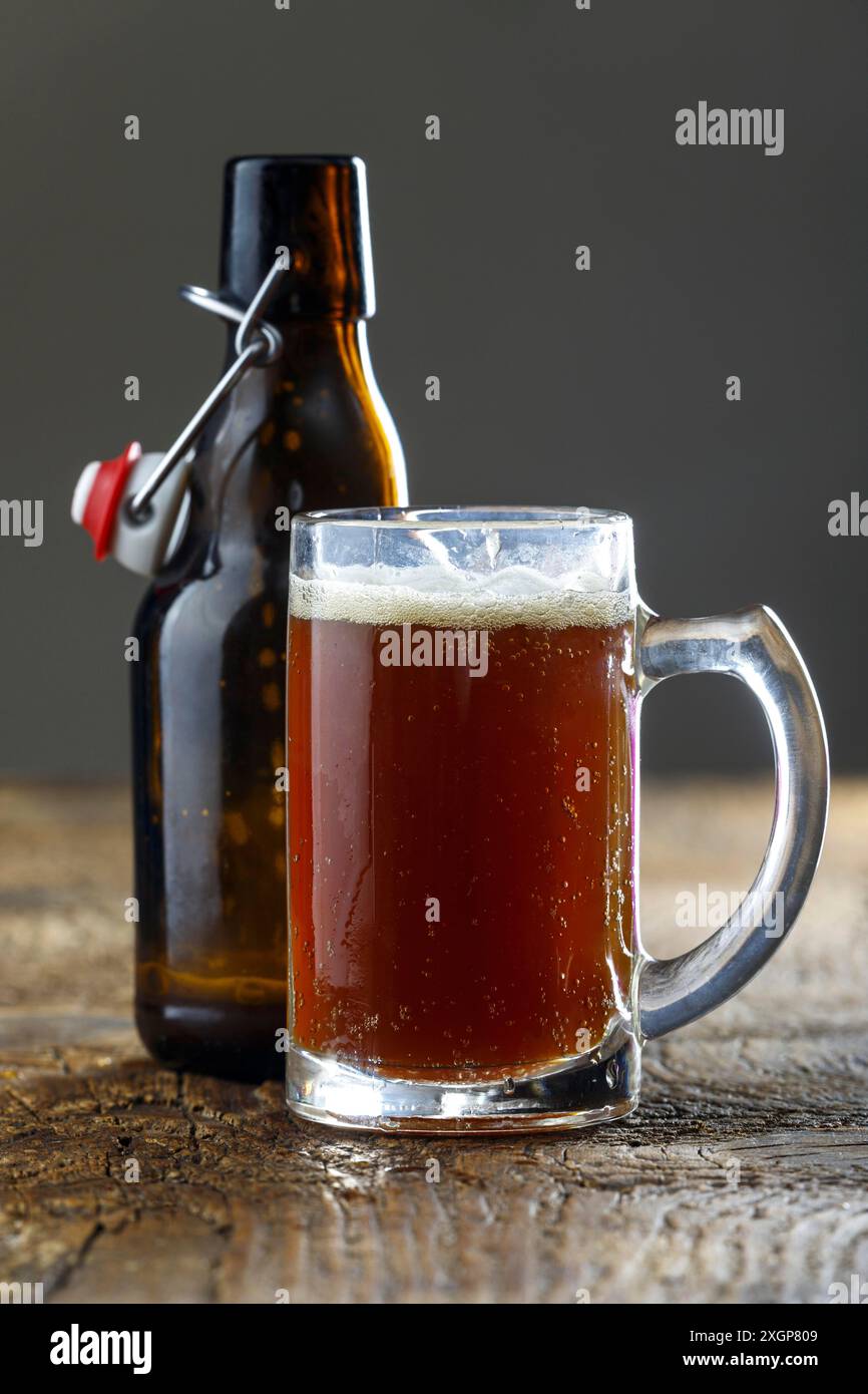 Homemade dark beer on wood Stock Photo - Alamy