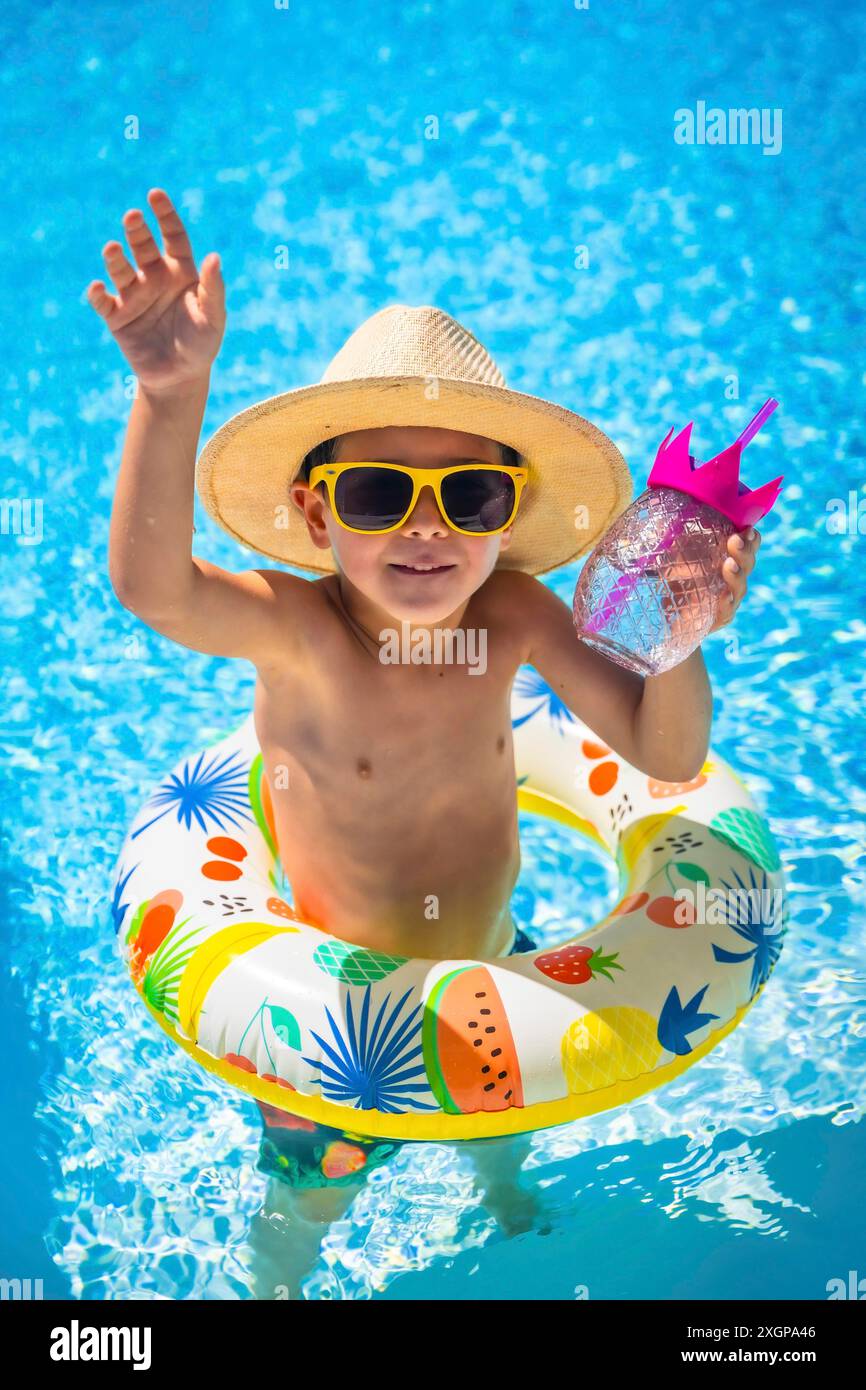 Vertical photo of a caucasian boy playing in a pool inside a rubber ...