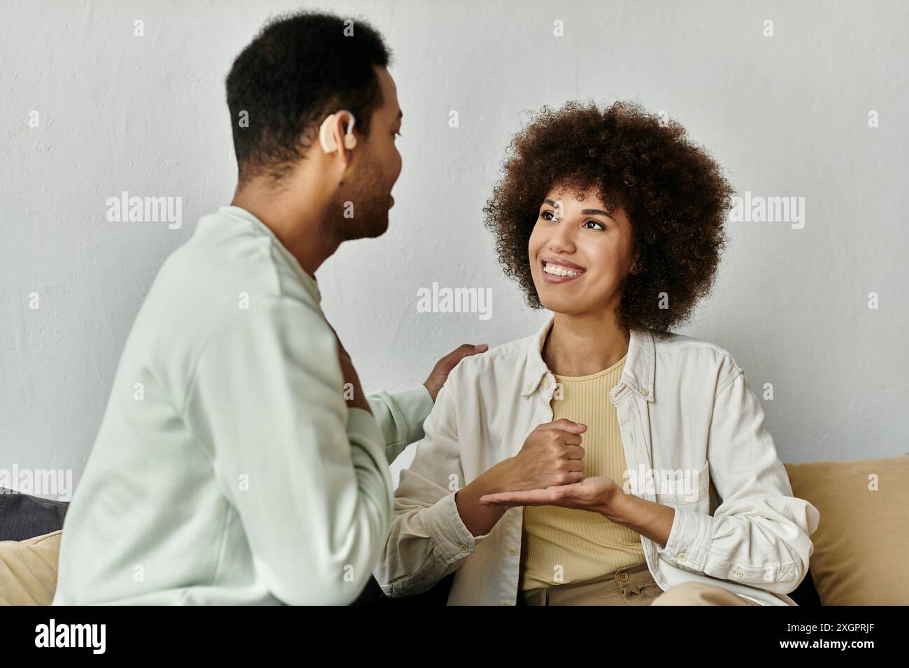 A happy African American couple communicates using sign language at home. Stock Photo