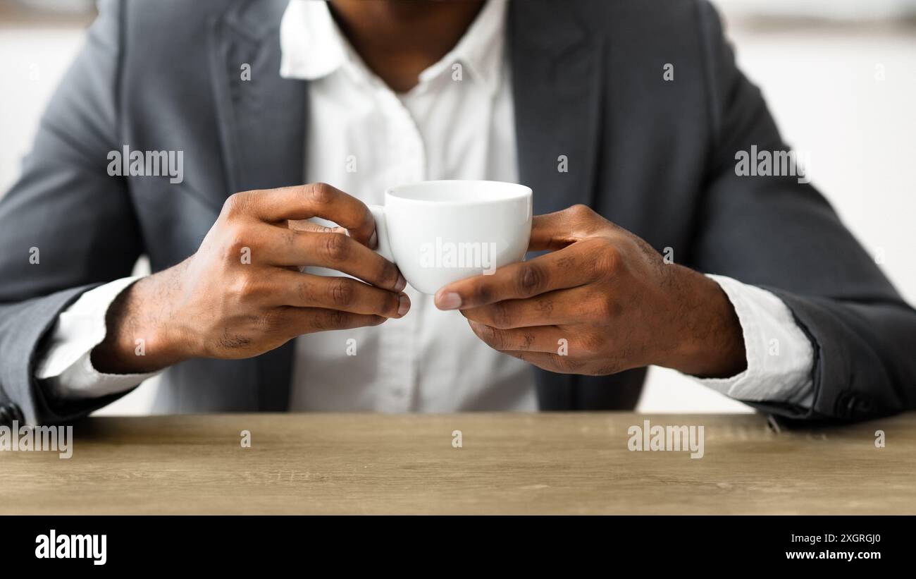 African american businessman drinking coffee at workplace Stock Photo