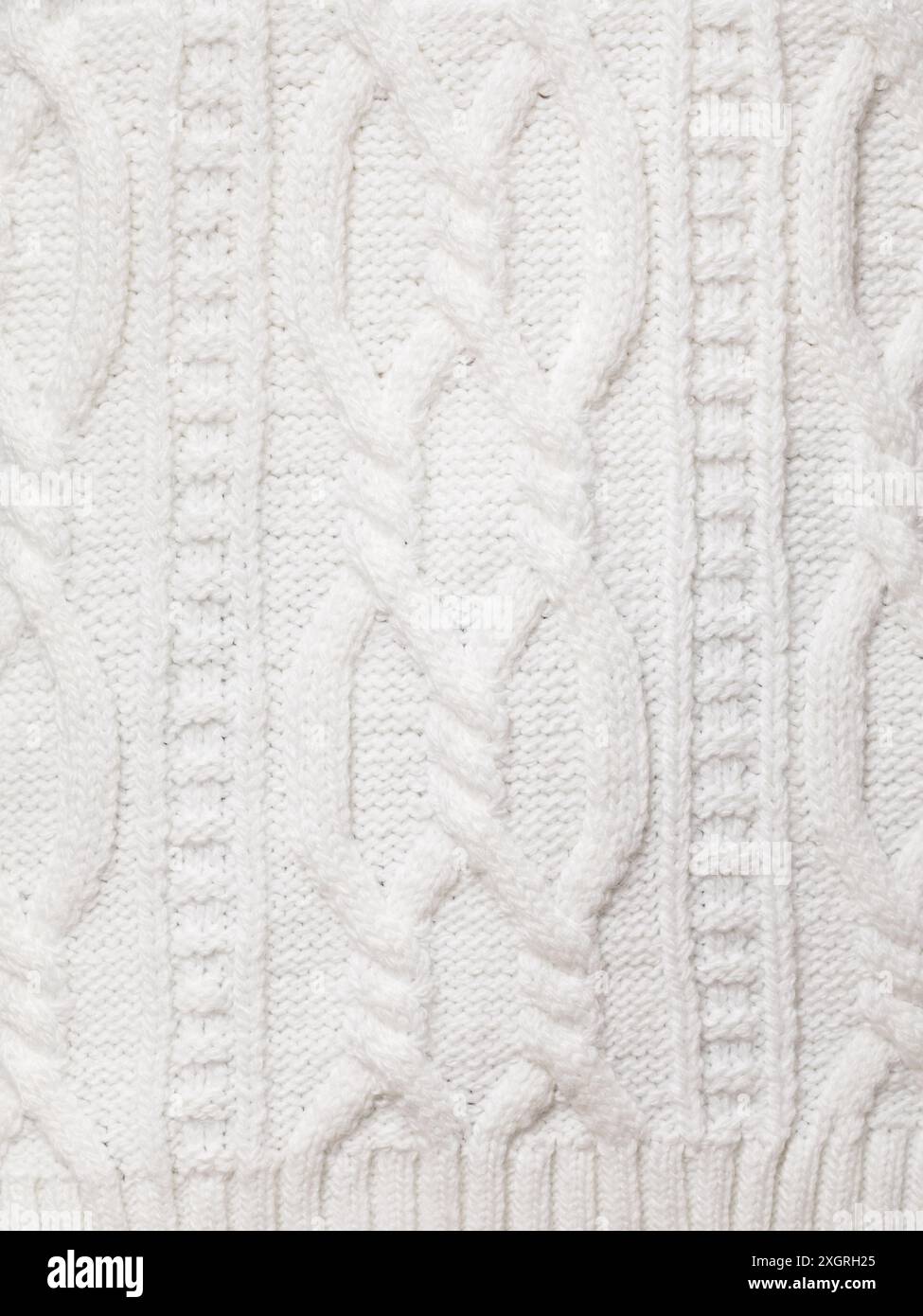 Real white knitted fabric with  cable pattern textured background Stock Photo