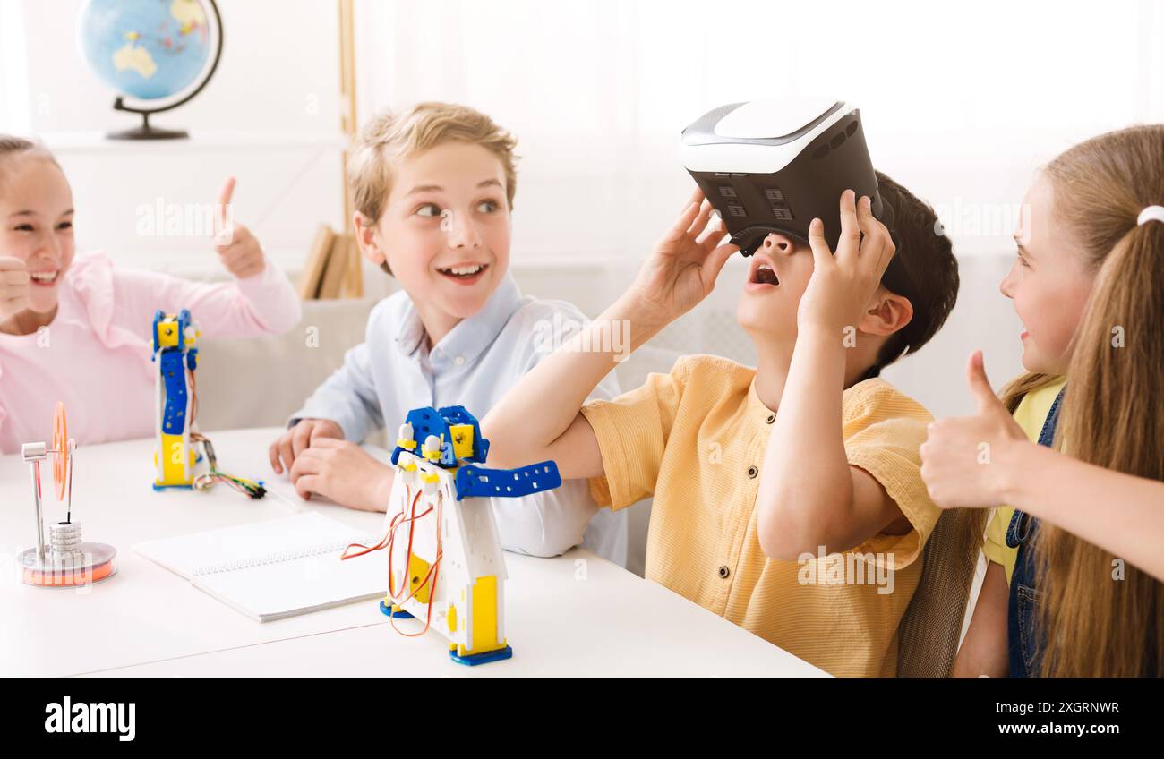 Children Using Virtual Reality Headset In Classroom Stock Photo