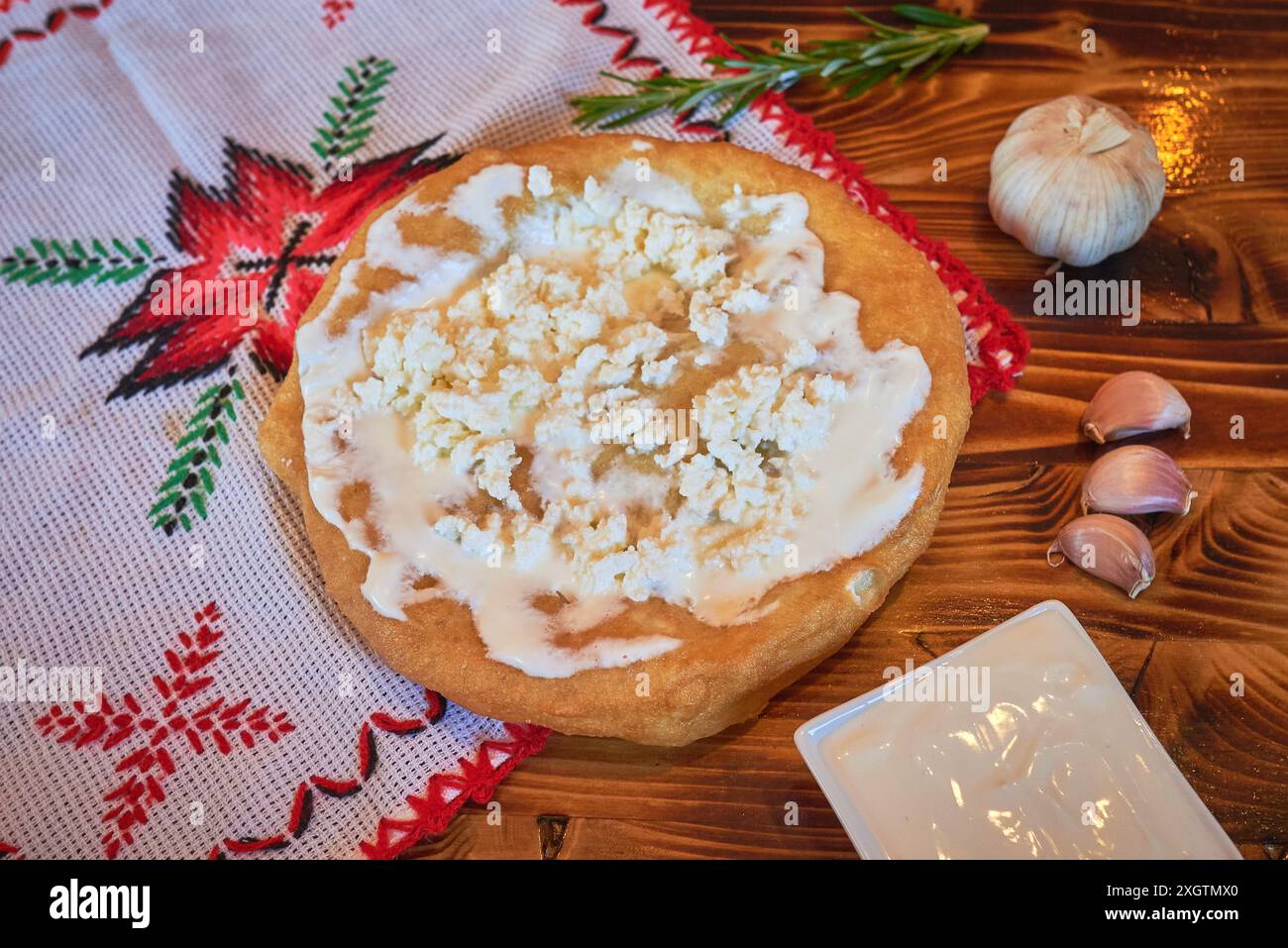 Langos with sour cream and cheese, a typical Hungarian food. Stock Photo