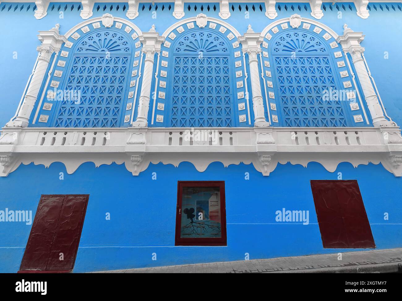 487 Triple arch window framed by 4 white columns, azure-blue Cine Cuba movie theater west side facade, early 1900s Eclectic building. Santiago-Cuba. Stock Photo