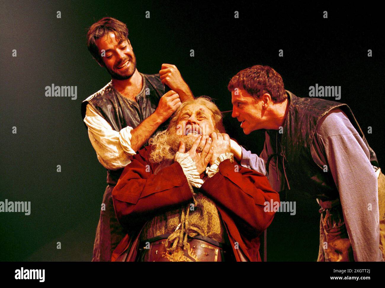 Poins and Hal torment Falstaff - l-r: Robert Portal (Poins), Desmond Barrit (John Falstaff), William Houston (Prince Hal) in HENRY IV part ii by Shakespeare at the Royal Shakespeare Company (RSC), Swan Theatre, Stratford-upon-Avon  29/06/2000  set design: Es Devin  costumes: Kandis Cook  lighting: Tim Mitchell  fights: Terry King  director: Michael Attenborough Stock Photo