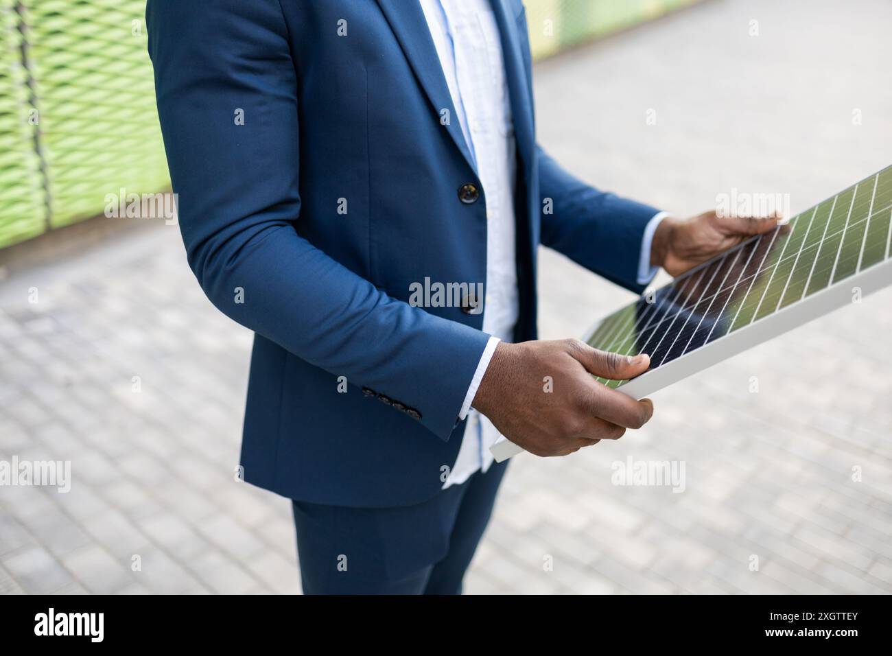 Cropped unrecognizable image of a Black businessman's hands analyzing a solar panel Stock Photo