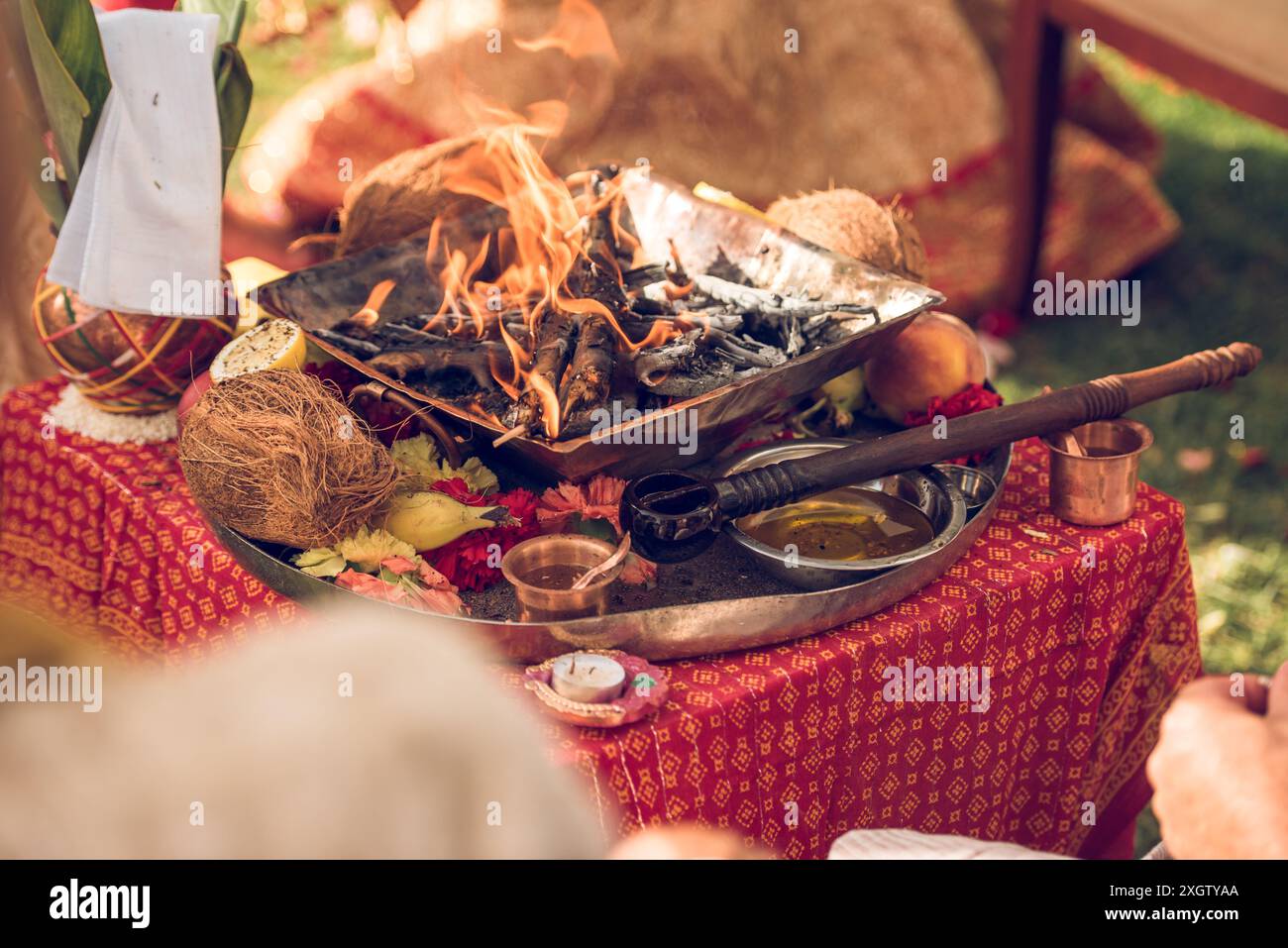 A vivid look at traditional Indian wedding rituals featuring essential items like a flame-lit havan kund, coconuts, and ritualistic objects. Backdrop Stock Photo