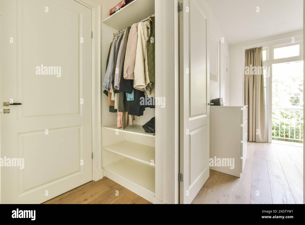A Bright Organized Closet Space Revealing A Well Ordered Selection Of