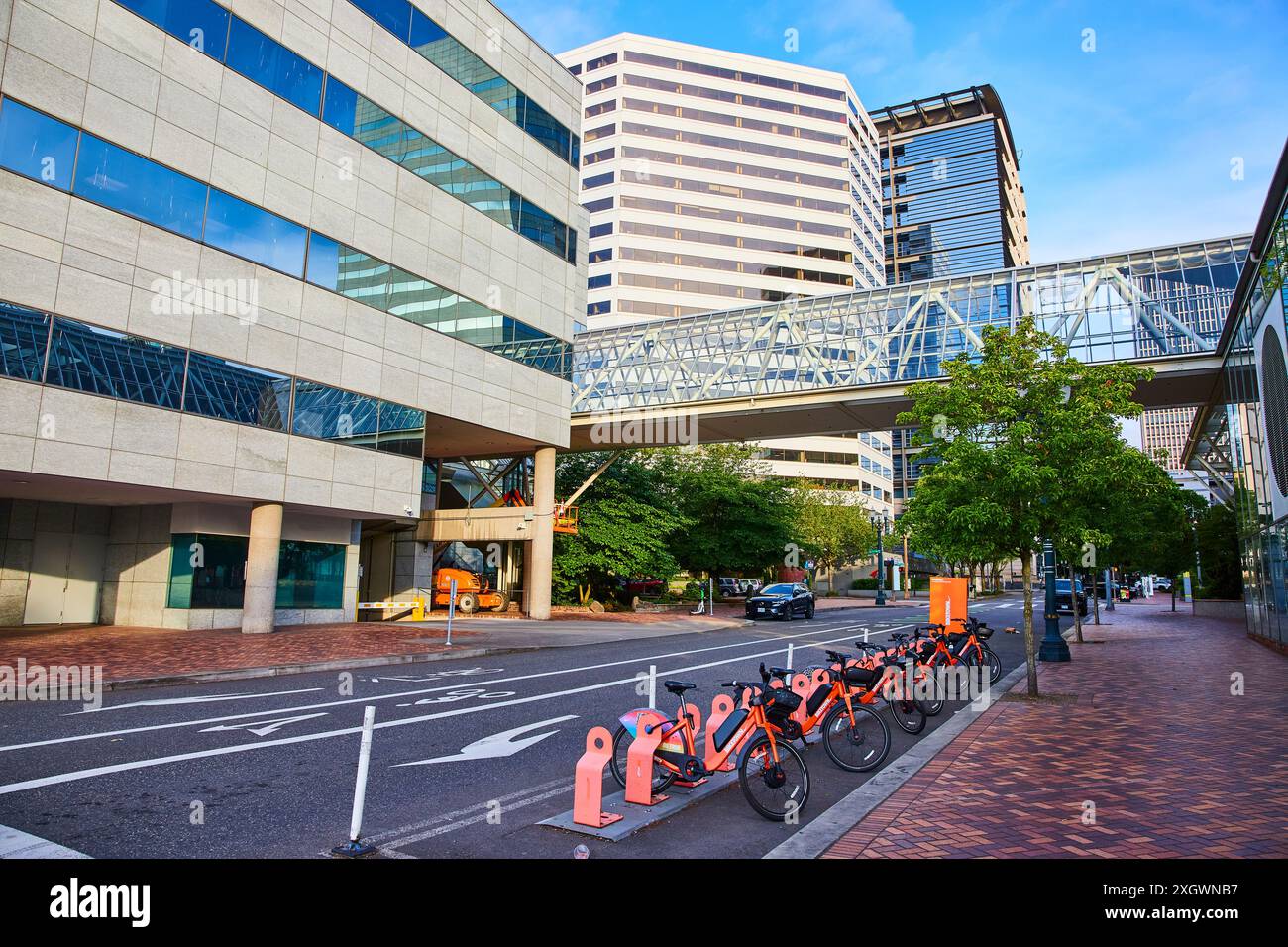 Urban Business District with Bike Sharing and Skywalk Street Level Perspective Stock Photo