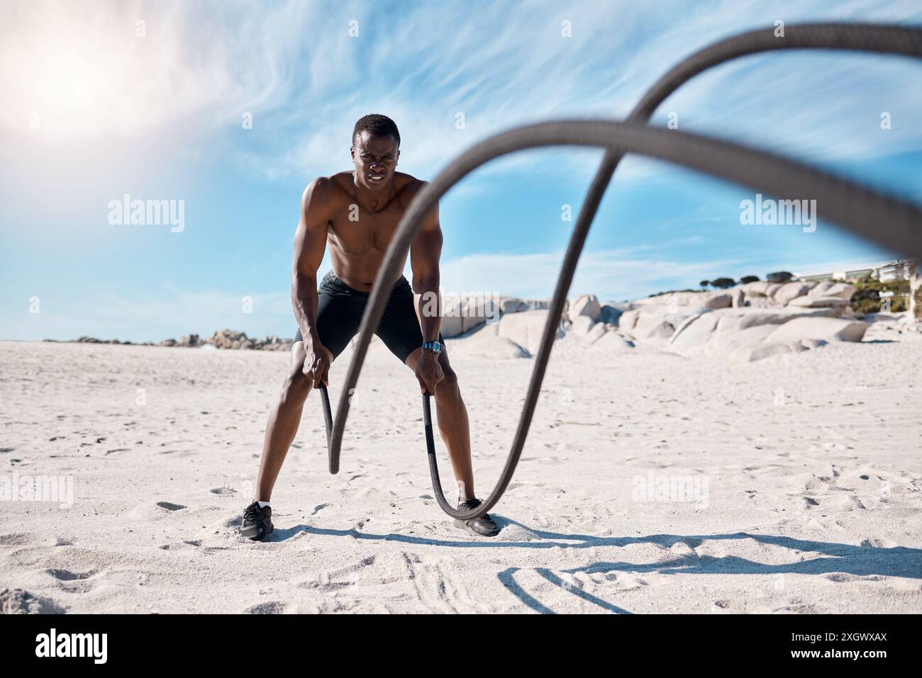 Athlete, fitness and battle ropes on beach for exercise, workout and ...