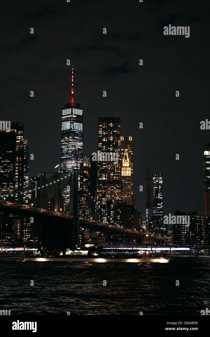 New York City skyline with illuminated skyscrapers and Brooklyn Bridge ...