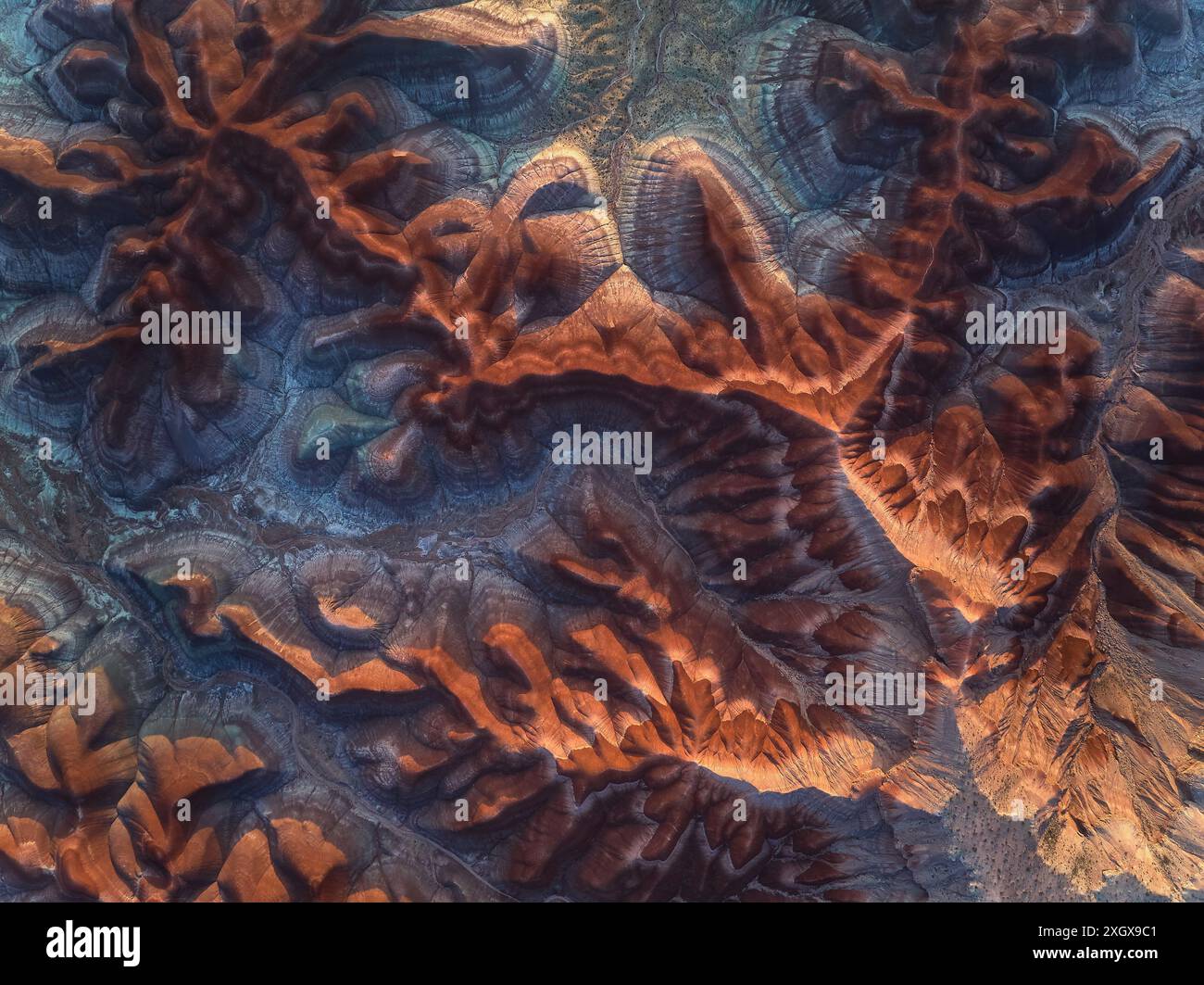 A drone view over Badlands hills in Utah, USA at sunset with golden sky Stock Photo