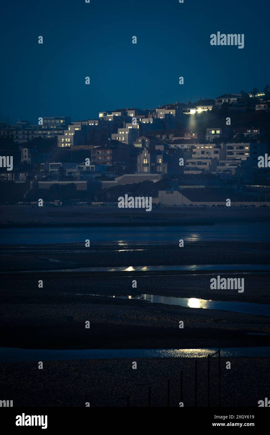 Late view of Foz do Arelho at sunset from Bom Sucesso beach across the entrance to the Obidos lagoon on the Silver Coast in Portugal Stock Photo