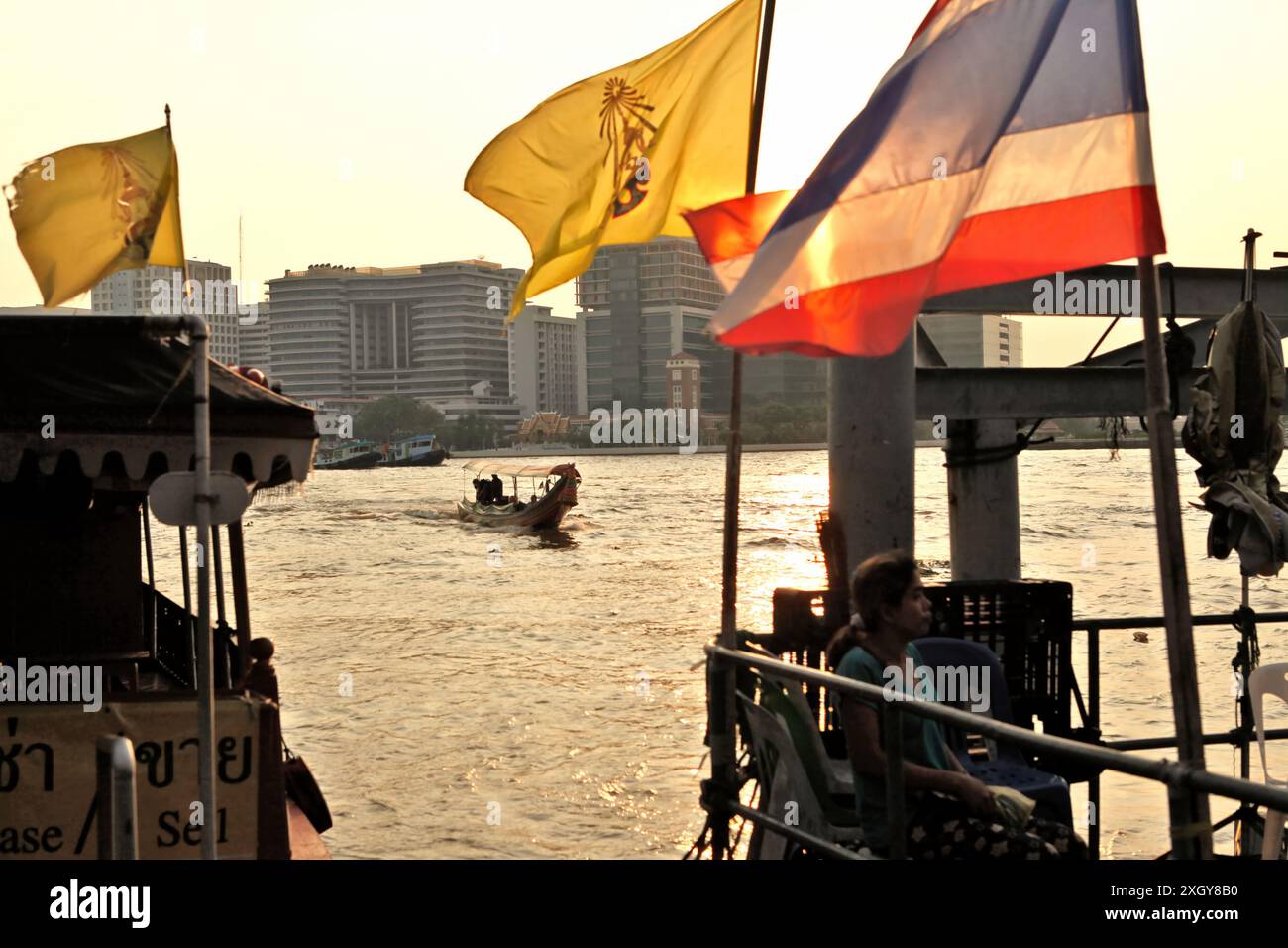a-tourism-boat-approaching-a-waterbus-station-decorated-with-a-thailand