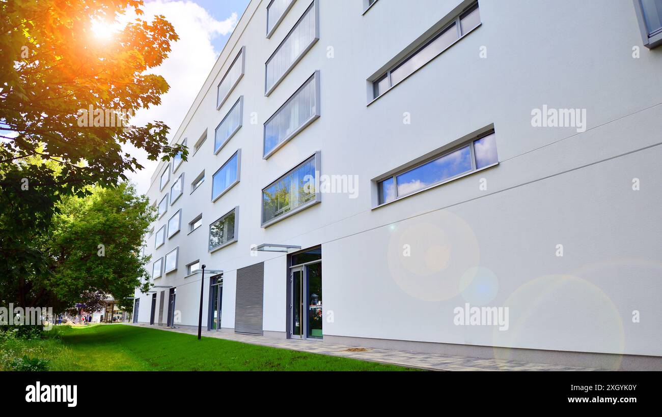 Modern residential building with new apartments in a green residential ... - Green Apartment Home Builders