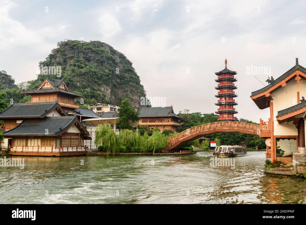Beautiful bridge over lake and traditional Chinese wooden houses in Guilin, China. Stock Photo