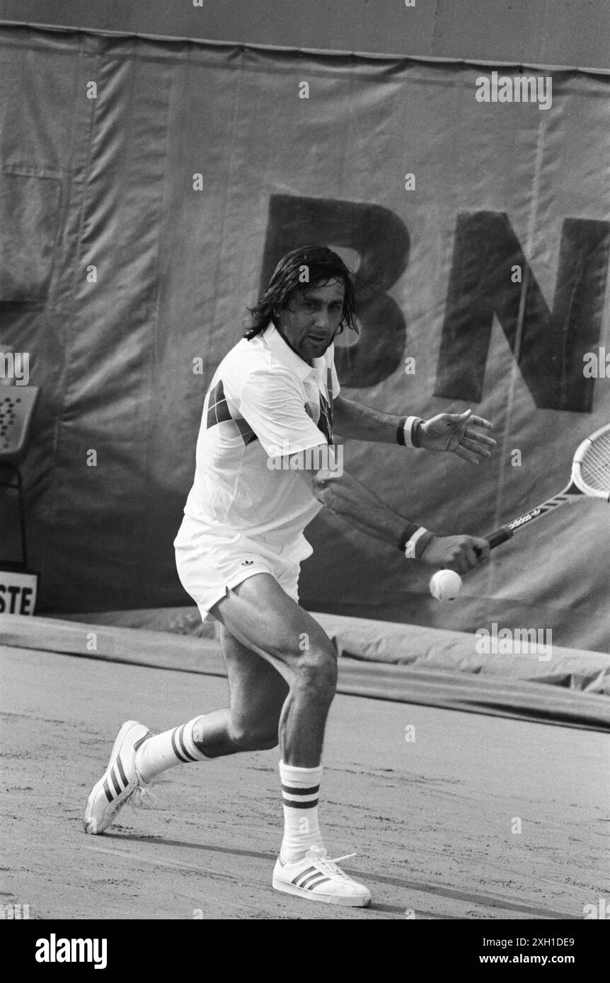 Romanian tennis player Ilie Nastase, attending a match of men's singles of the French Open. Paris, Roland-Garros stadium, June 1982 Stock Photo