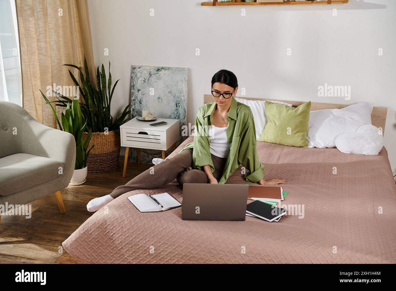Focused woman sitting on bed hi-res stock photography and images - Alamy