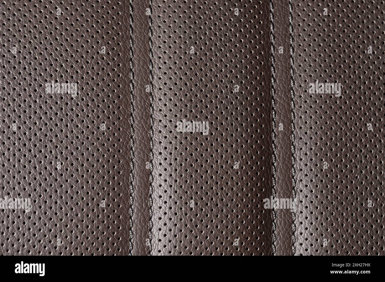Brown perforated leather with stitches macro close up view Stock Photo