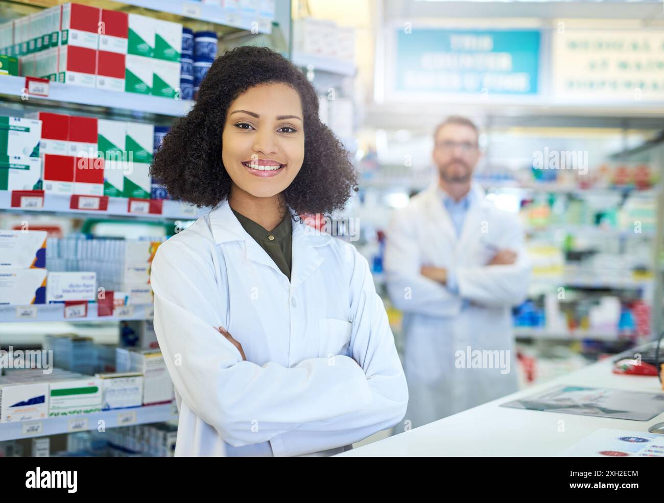 Healthcare, smile and portrait of woman in pharmacy with service, advice and happy in drug store. Confidence, arms crossed and pharmacist with Stock Photo