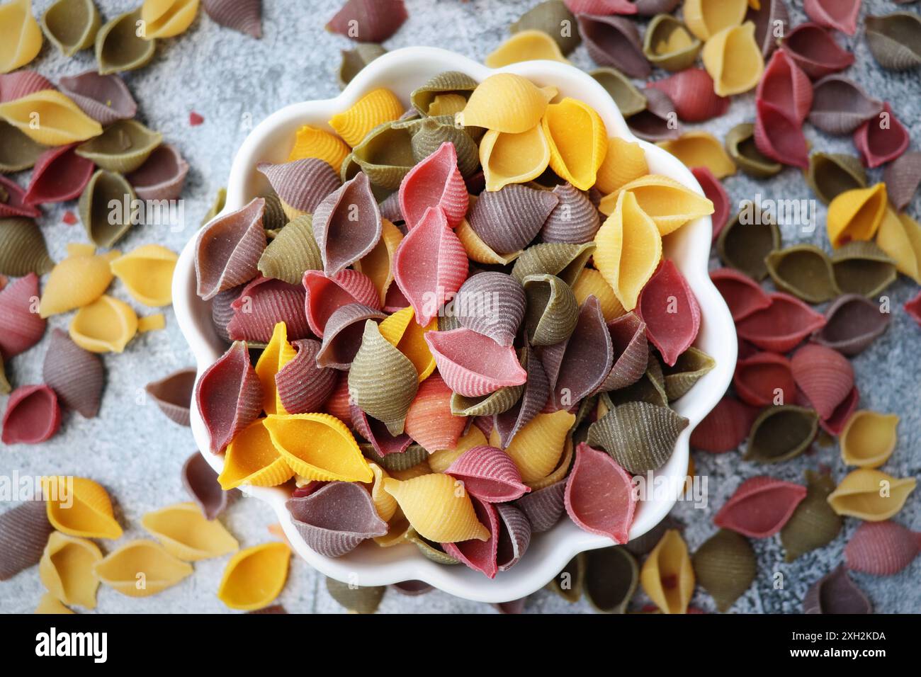 Colorful pasta background. Top view of five colors pasta shells on ...